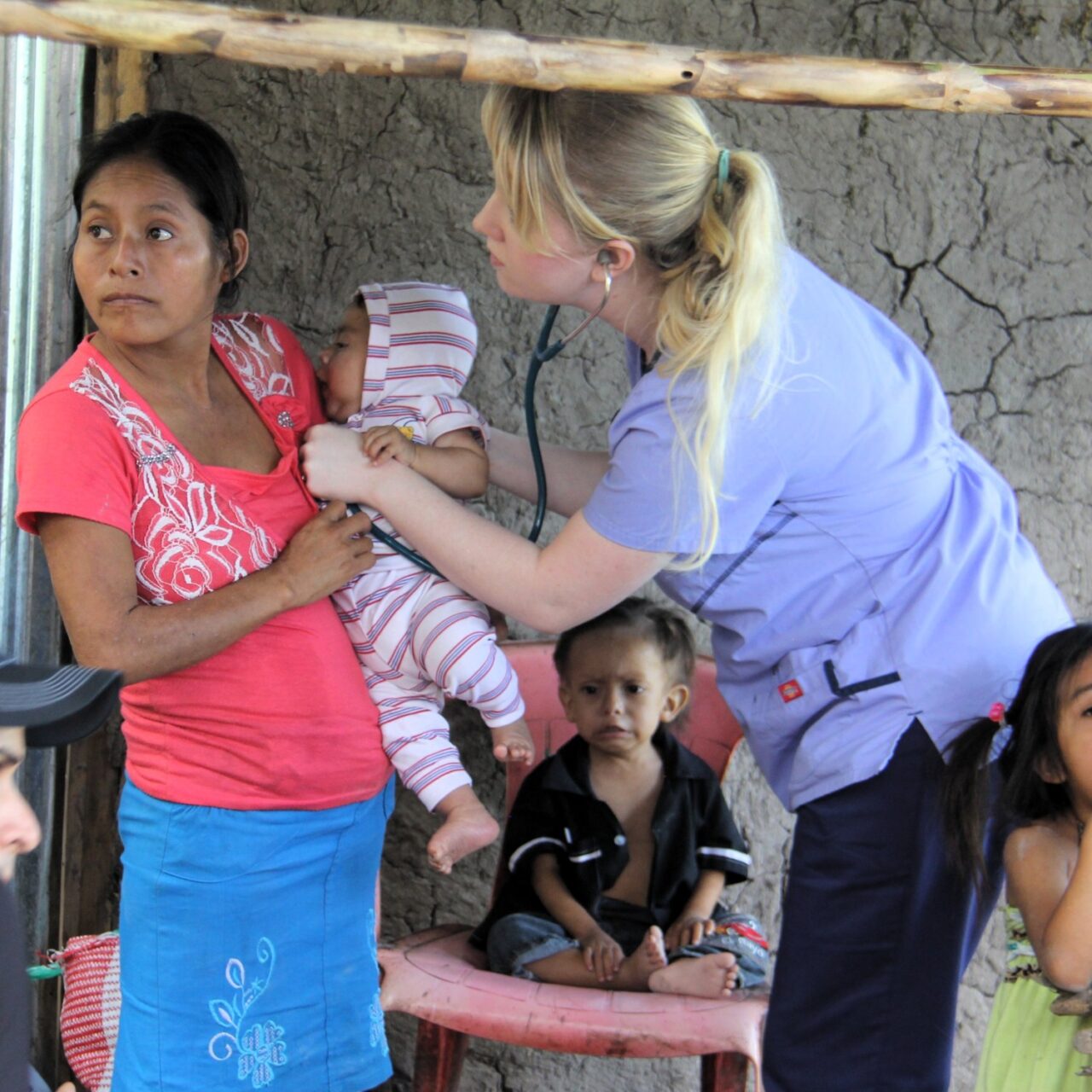 faithfully serving others | Medical Professional Helping Woman Holding a Baby