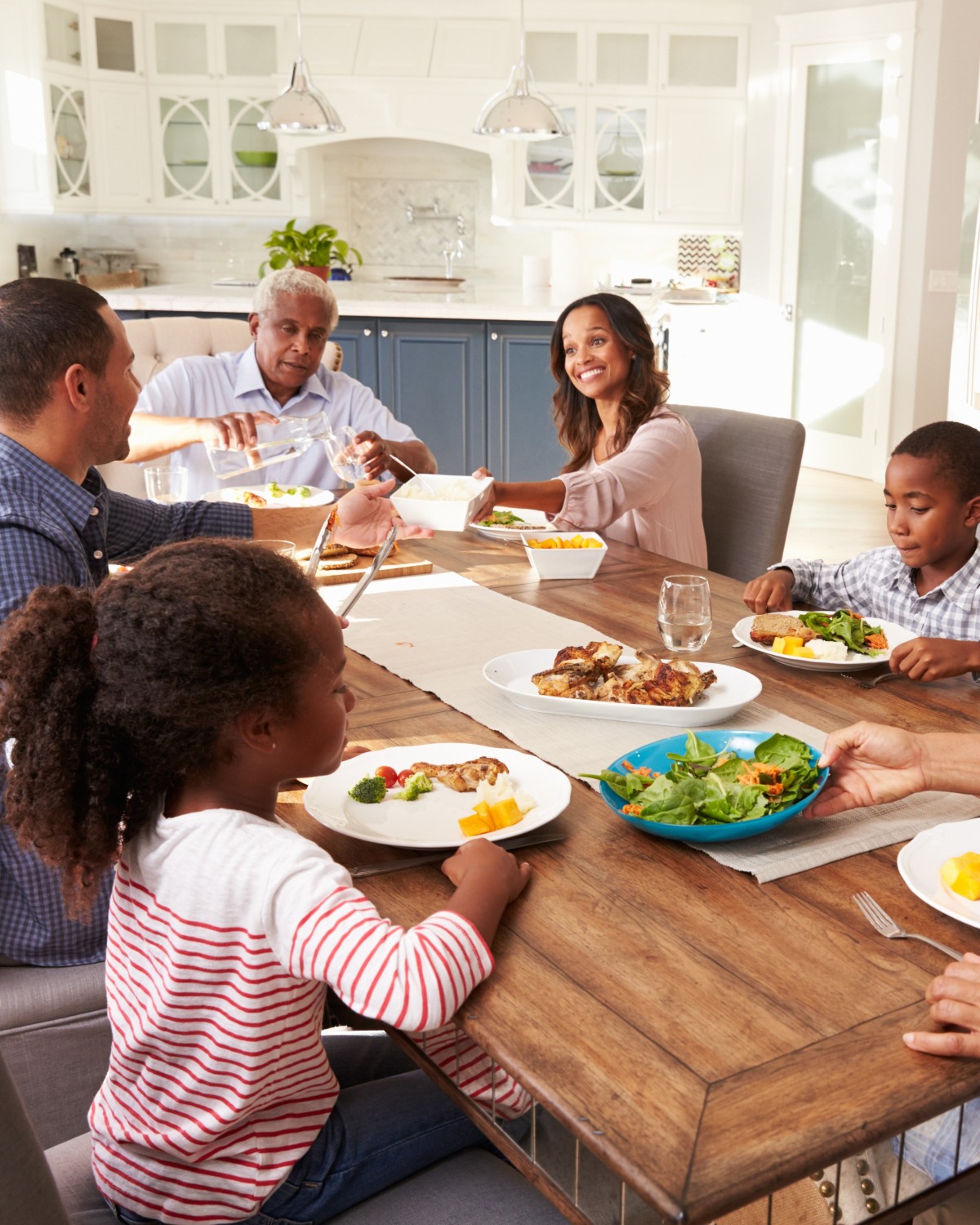 custom cabinetry designed for life | multi-generational family eating dinner