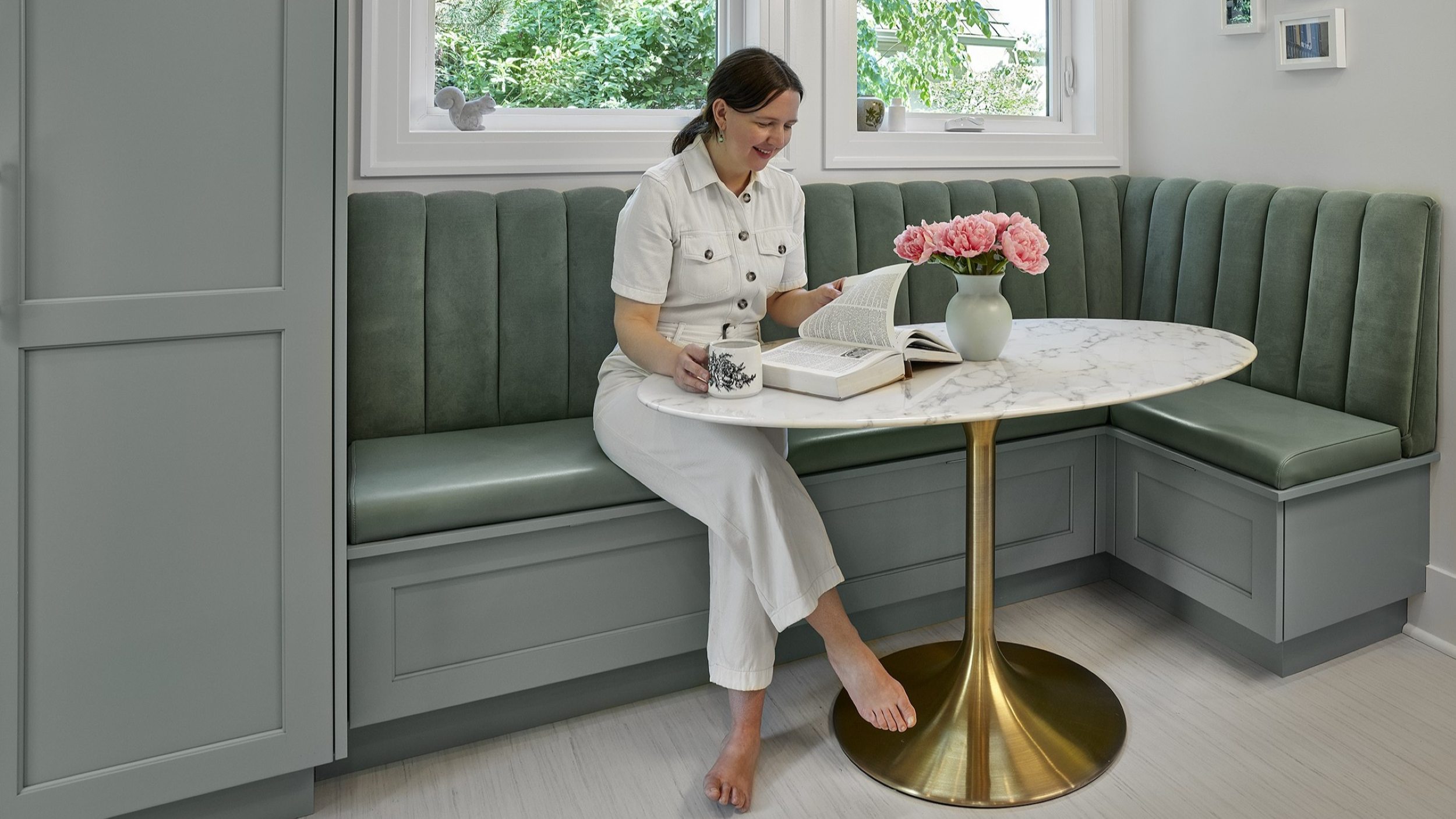 warranty and cabinet care 2 | Smiling woman Sitting at Banquette, Reading